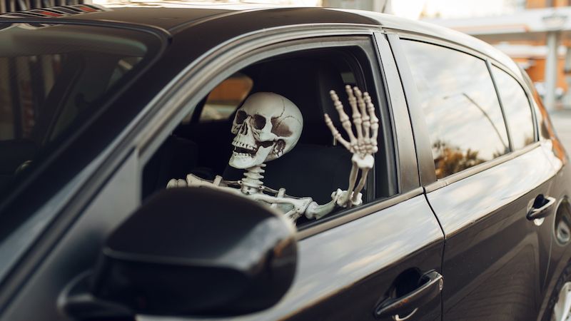 skeleton driving a car
